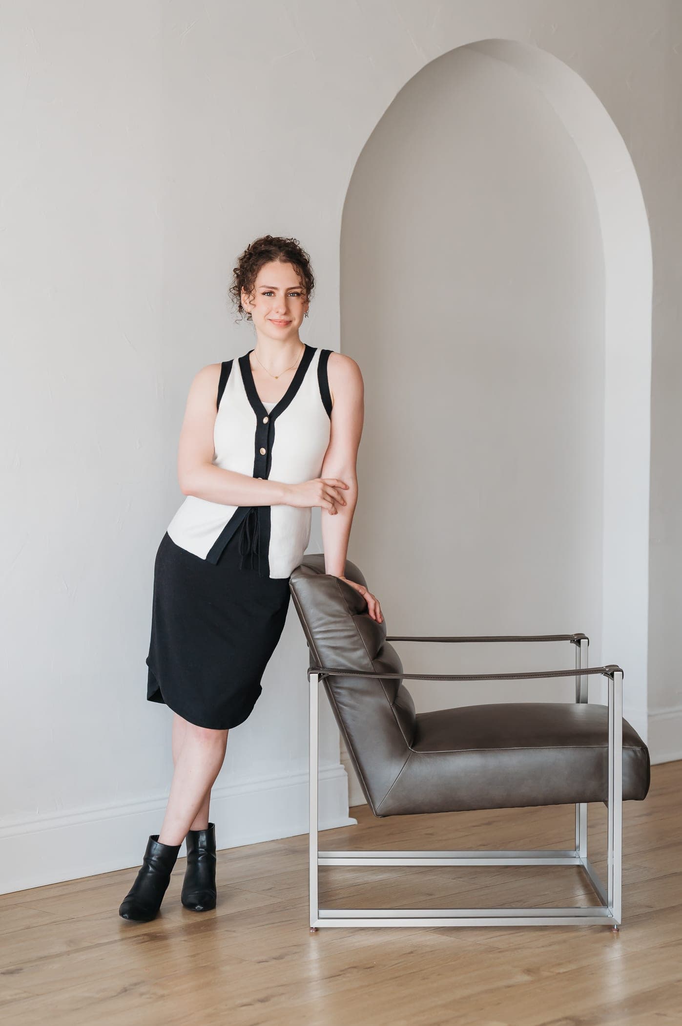 Donnie Newman standing in a bright room with an arched alcove behind her